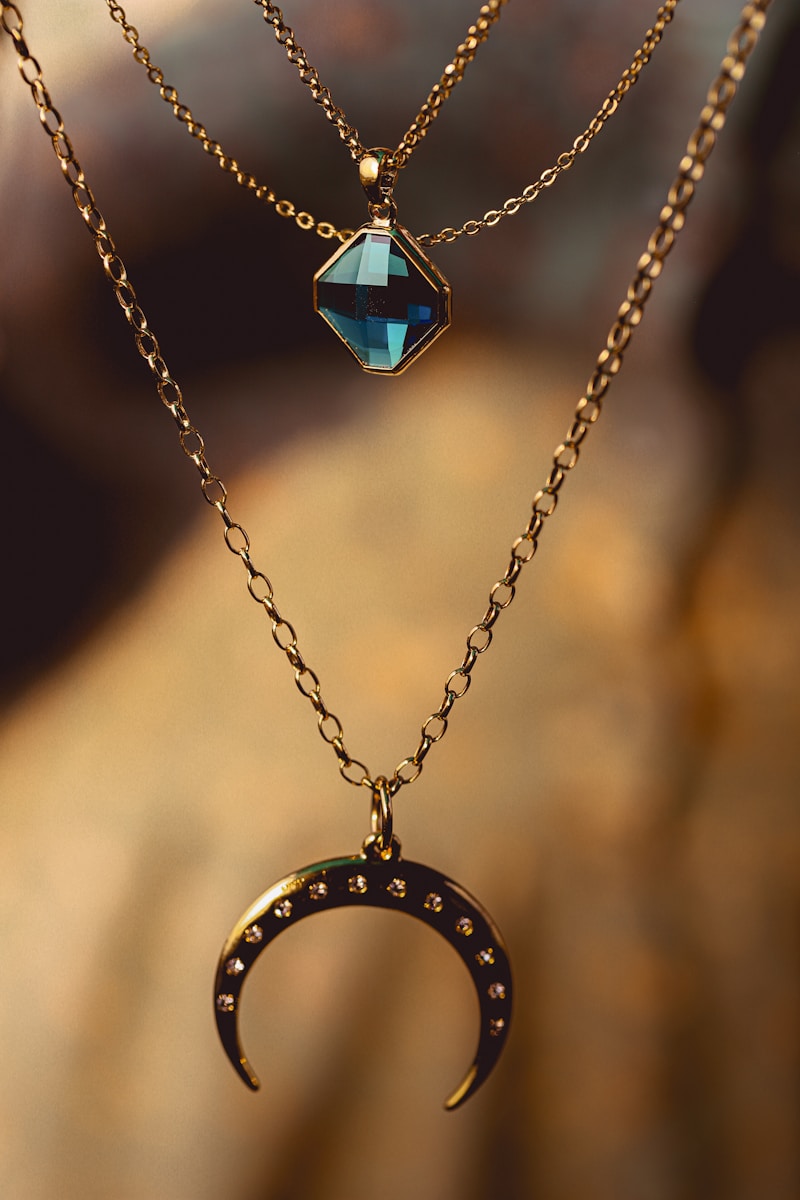 Photo by Andres Vera silver chain necklace with blue gemstone pendant